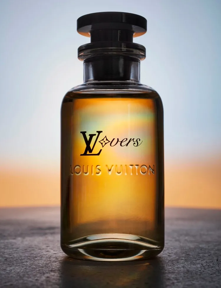 stilllife photograph of louis vuitton lover fragrance bottle on concrete surface with a sunset background