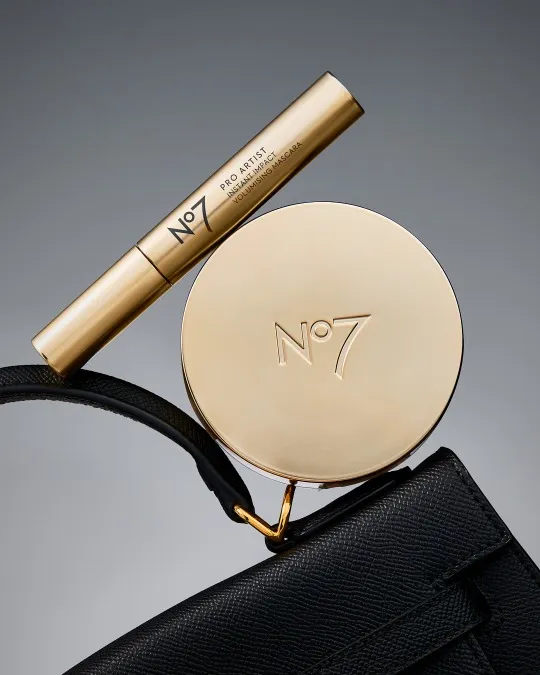 Commercial cosmetics photography for a beauty brand campaign. product balancing on handbag.